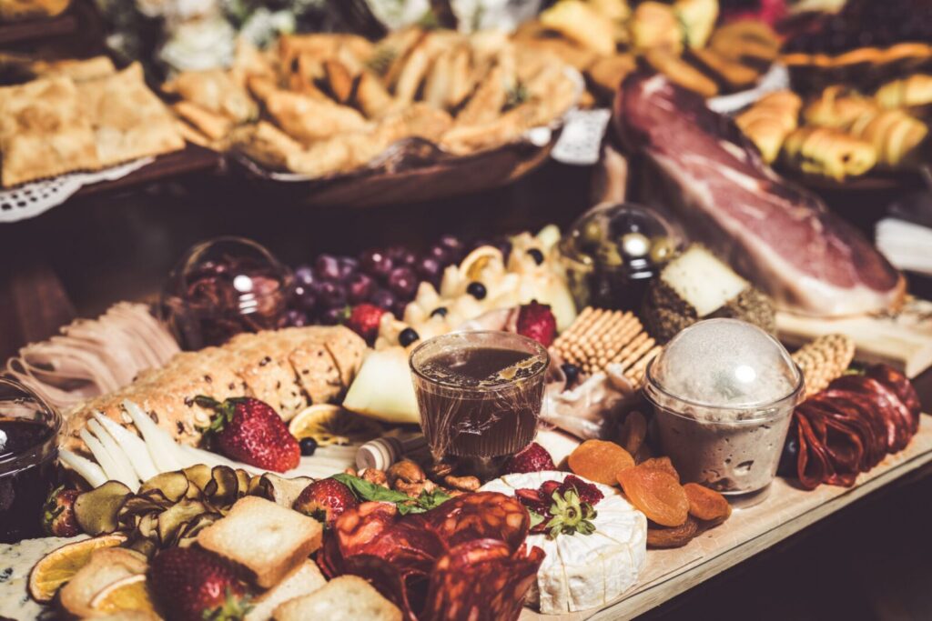A vibrant charcuterie board featuring assorted cheeses, meats, fruits, and pastries, ideal for culinary and lifestyle imagery.
